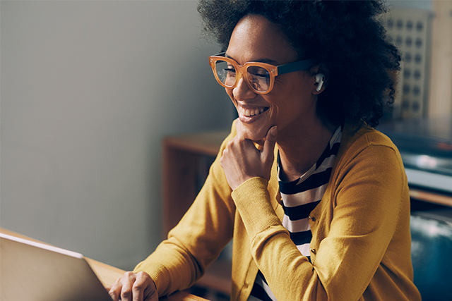 woman looking at laptop and smiling