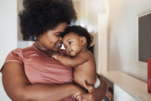 Woman holds baby in a diaper