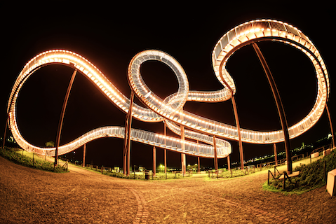 brightly lit roller coaster at night