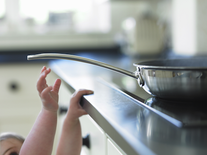 todder reaching for a pan on a hot stove