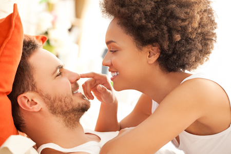 man and woman couple flirting in bed