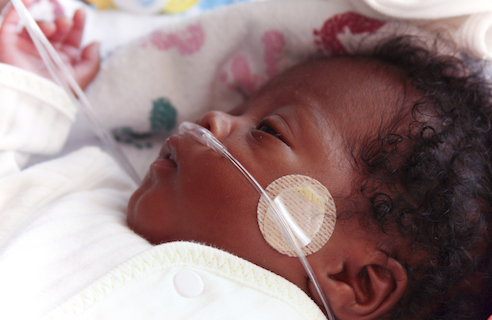 newborn baby lying in the hospital