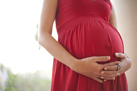 pregnant woman holding her stomach