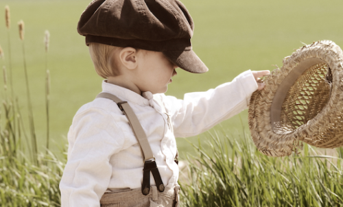 little boy dressed up in old-fashioned clothes