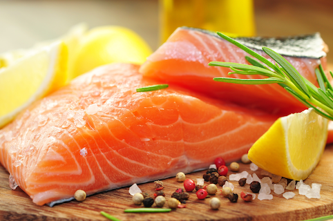 fresh salmon sitting on a cutting board