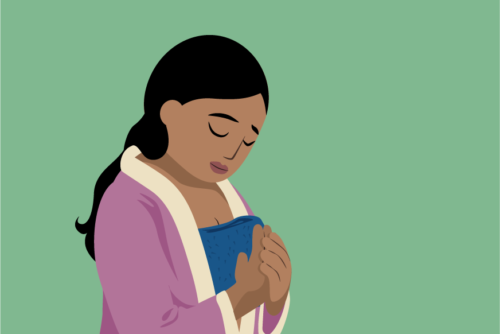 Woman applying warm compress to her breasts because of breast engorgement.
