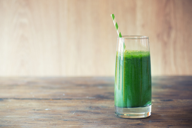 A glass with a green drink that has many nutrients to help with fertility.