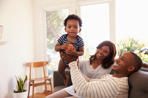 Mom, dad and baby on couch