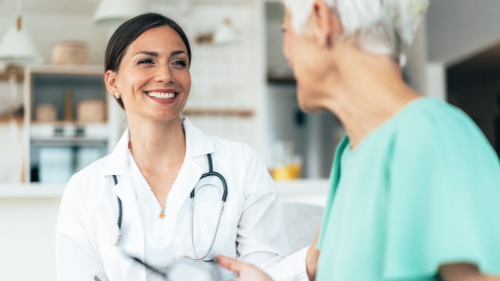 Doctor smiling and speaking to patient.
