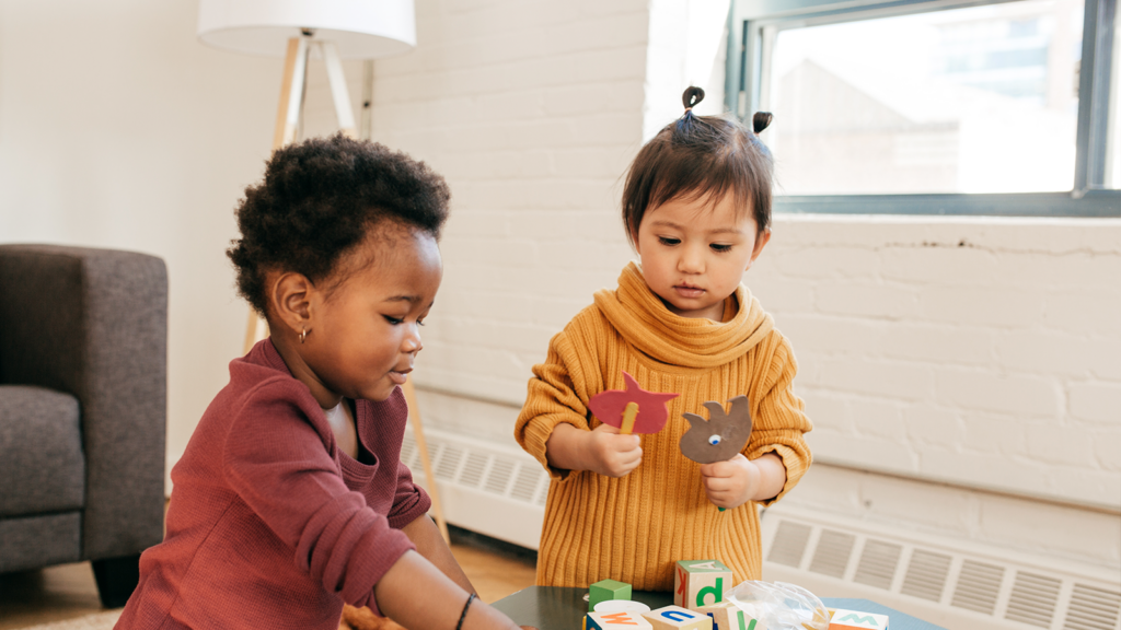 Two children playing with blocks